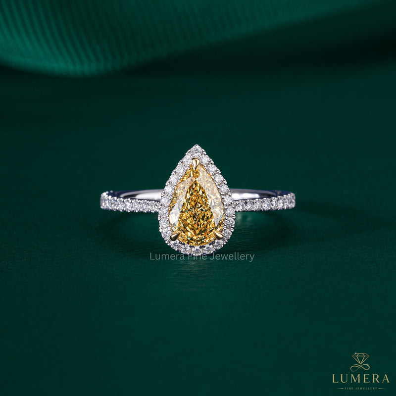 pear shaped yellow diamond ring with two tone engagement ring.