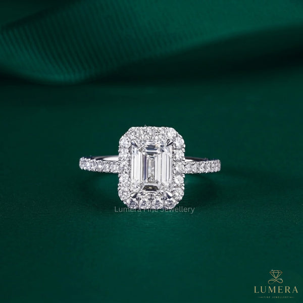emerald cut engagement ring diamond with 4 claw prong setting.