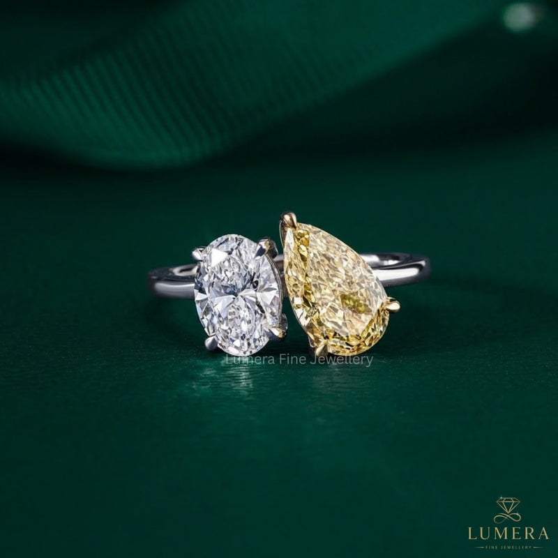 oval ring with pear side stones with claw prong setting.