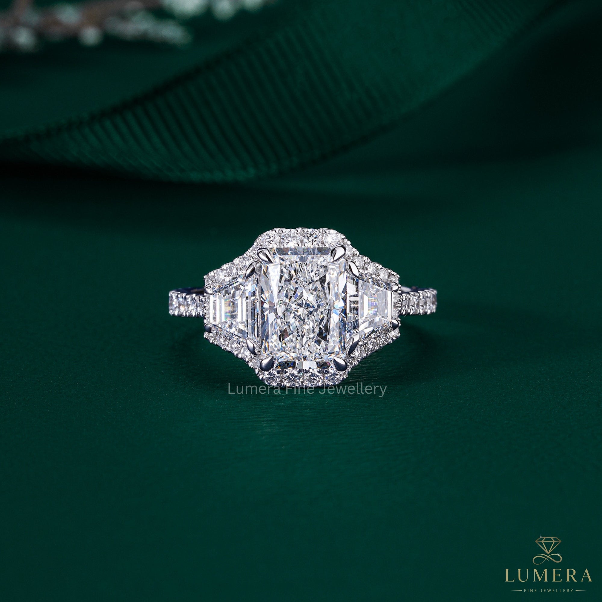 radiant cut three stone engagement ring with trapezoid side stone.
