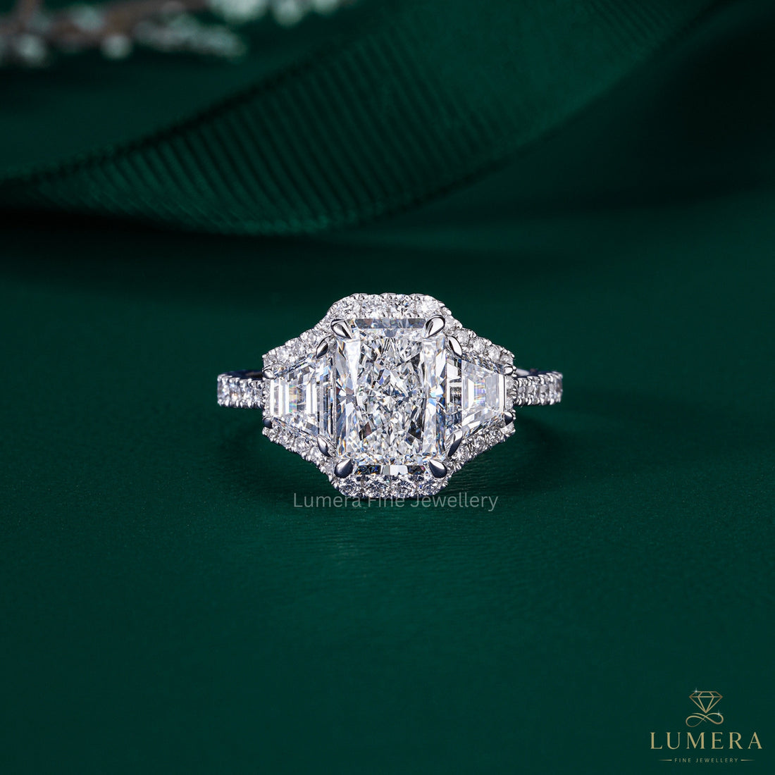 radiant cut three stone engagement ring with trapezoid side stone.
