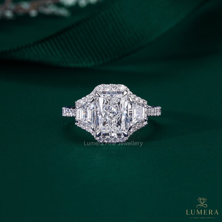 radiant cut three stone engagement ring with trapezoid side stone.
