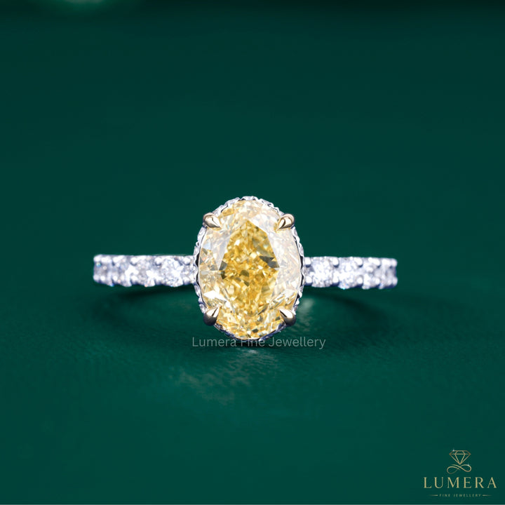 oval yellow diamond ring with two tone gold ring.