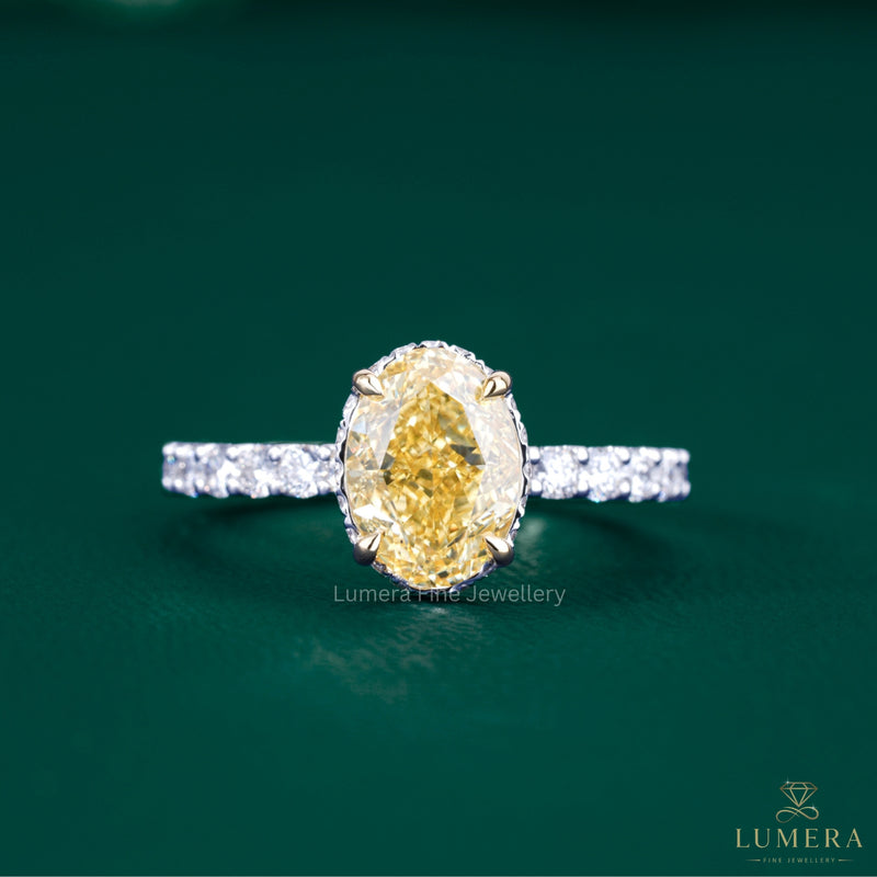 oval yellow diamond ring with two tone gold ring.