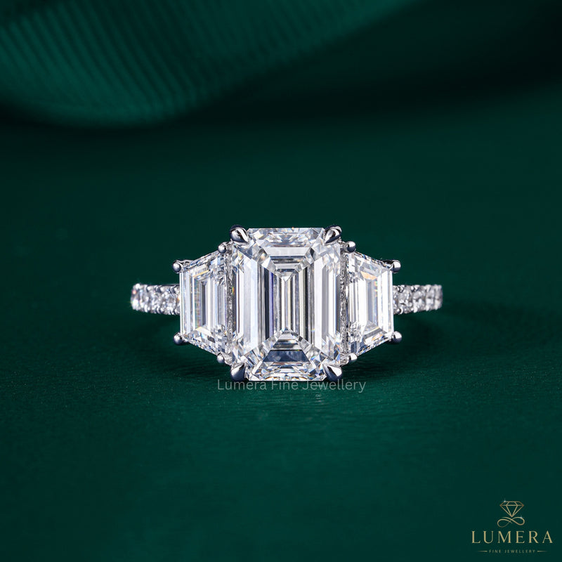trilliogy ring with emerald three stone ring.