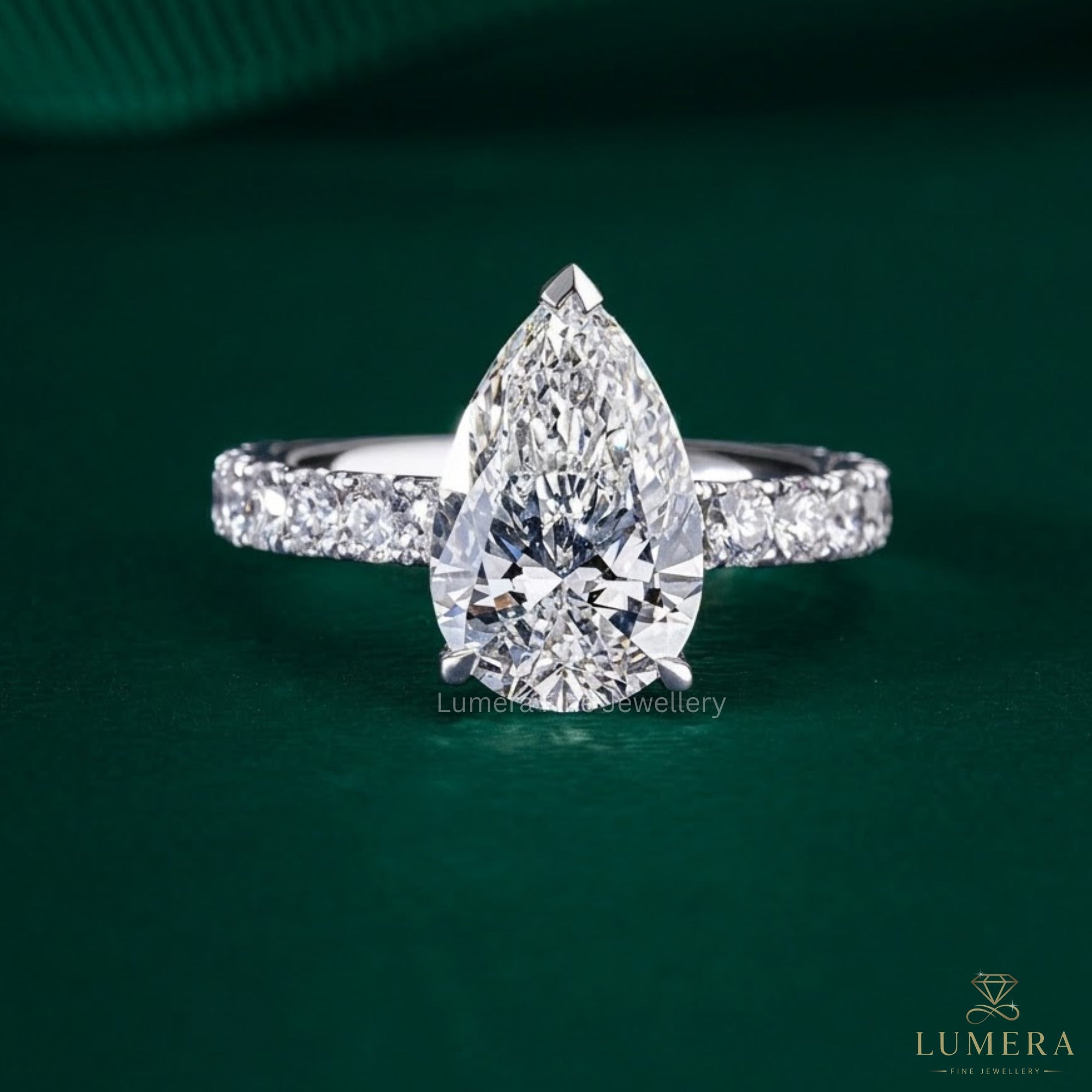 pear shaped diamond ring with pave band ring.
