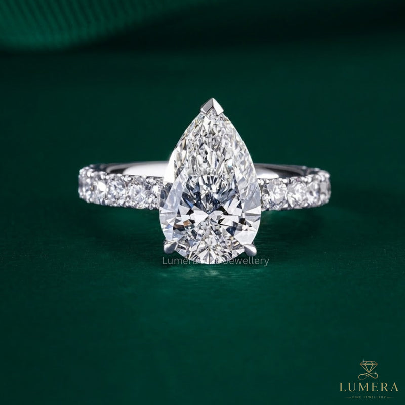 pear shaped diamond ring with pave band ring.
