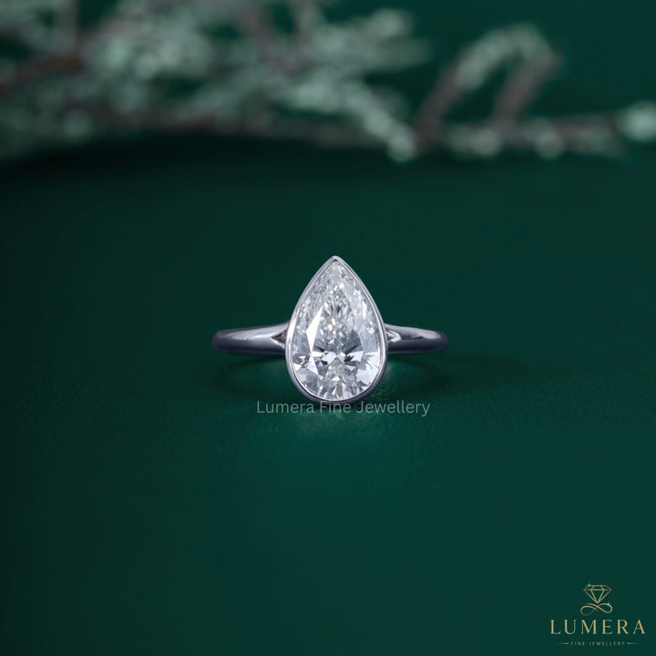 Pear shaped solitaire ring with almond solitaire ring.
