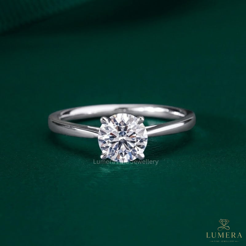 round diamond engagement ring with claw prong setting.