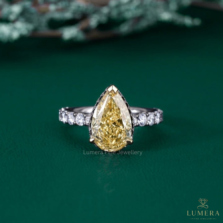 yellow pear diamond ring with two tone gold ring.