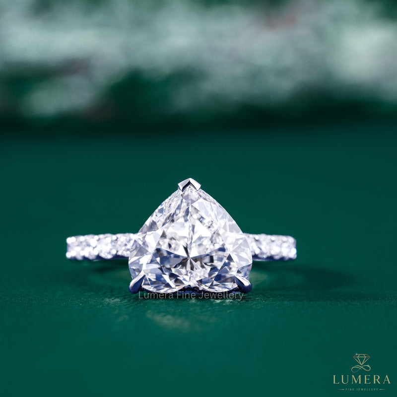 Heart cut engagement ring with hidden halo.