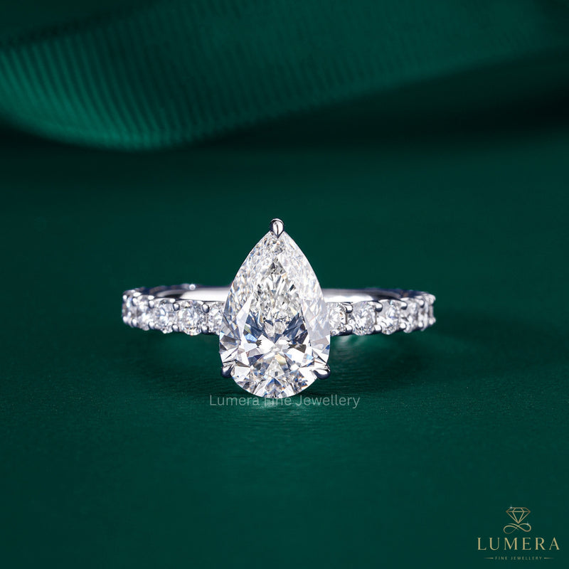 pear engagement ring with pave setting ring.
