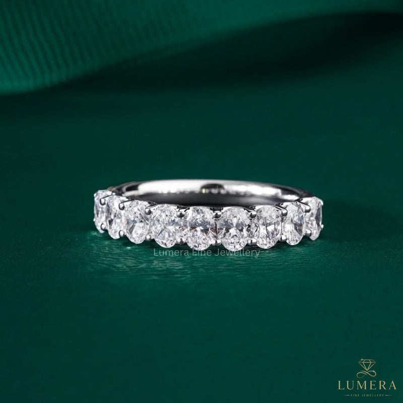 oval diamond wedding band with shared prong setting.

