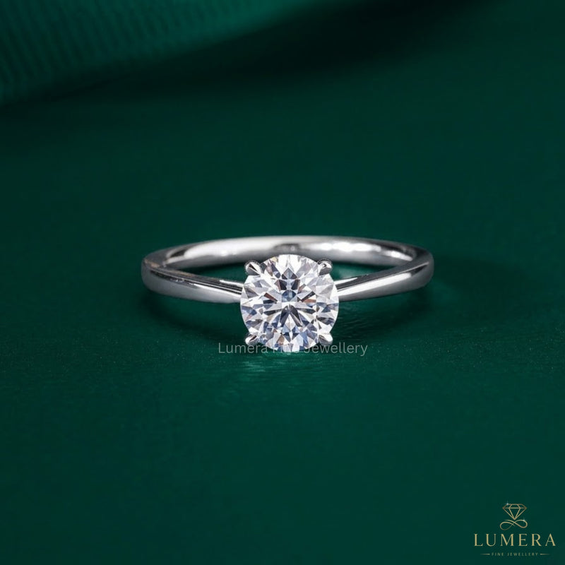 round solitaire engagement ring with cathedral setting ring.

