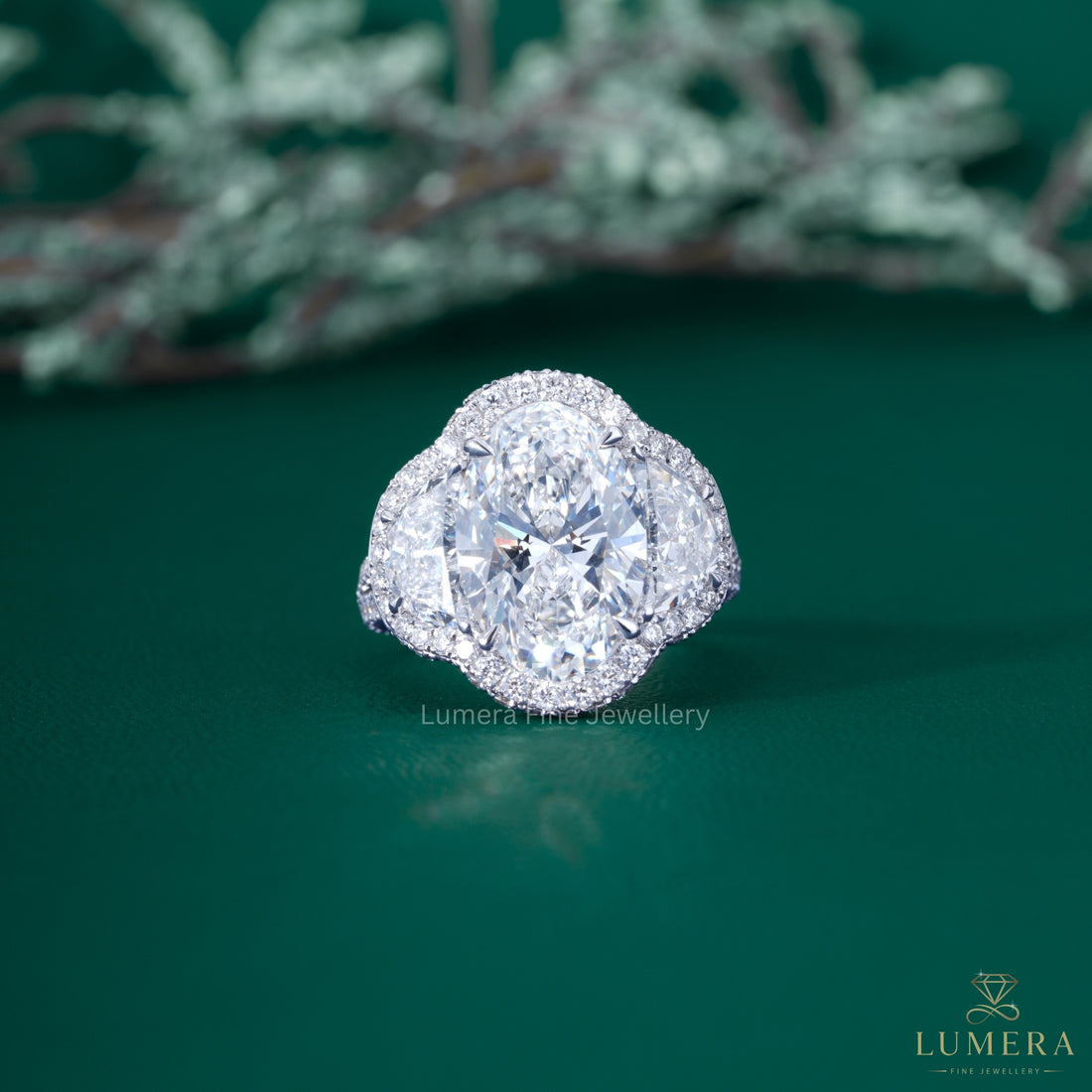 Three stone oval engagement ring with Half moon cut side stone.