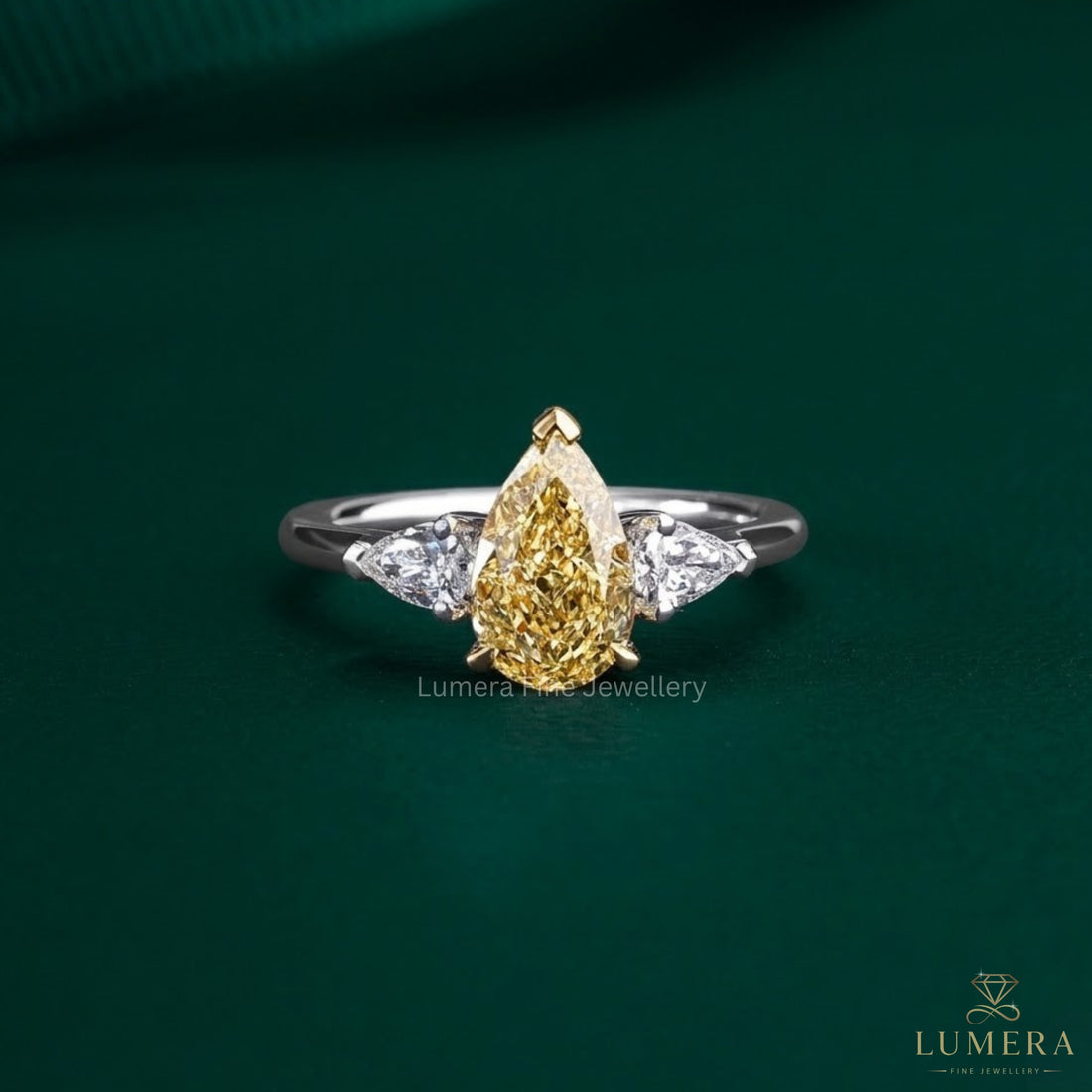 pear cut engagement ring with yellow diamond ring.
