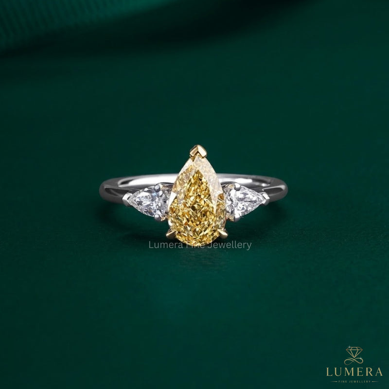 pear cut engagement ring with yellow diamond ring.
