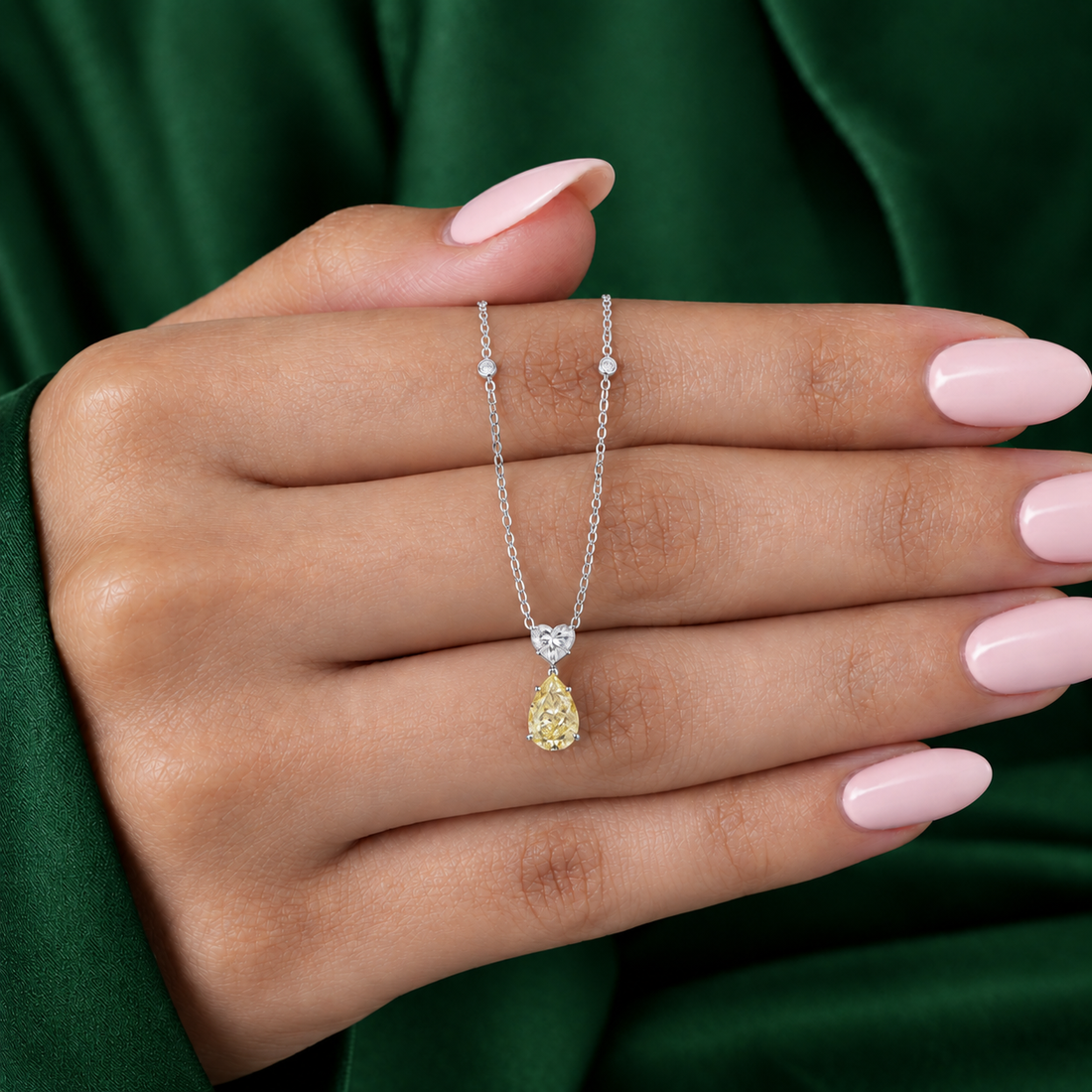 two tone gold pendant with round cut station chain.
