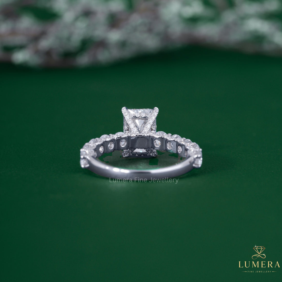Radiant engagement ring with u prong pave band.