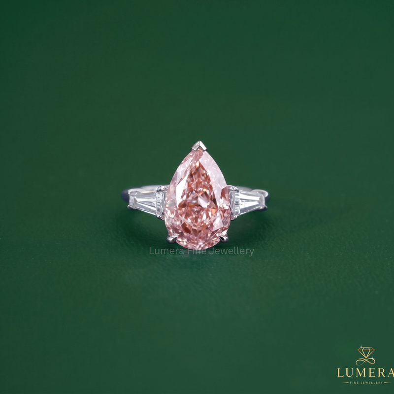 Pear shaped diamond ring featuring a pink diamond ring.
