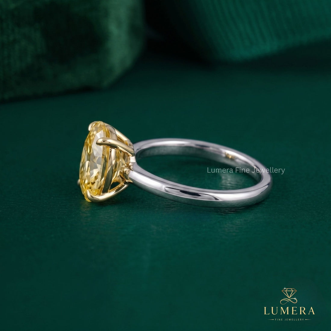 oval engagement ring on two tone ring.
