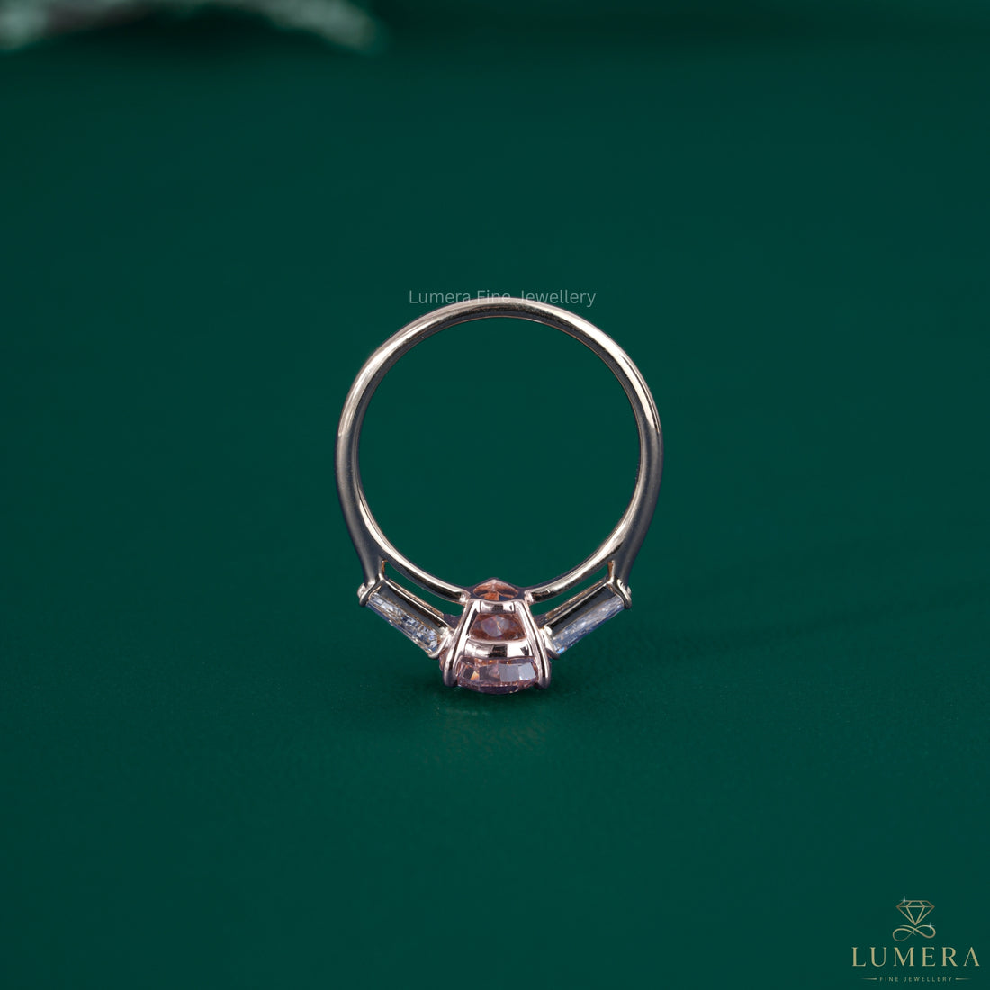 Pink stone engagement ring beside a basket setting ring.