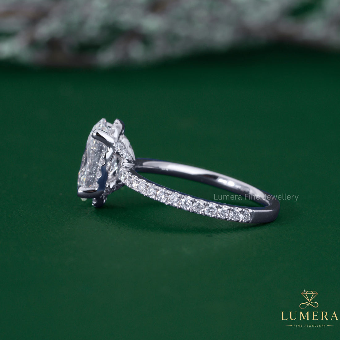 Oval cut diamond ring with pave setting ring.