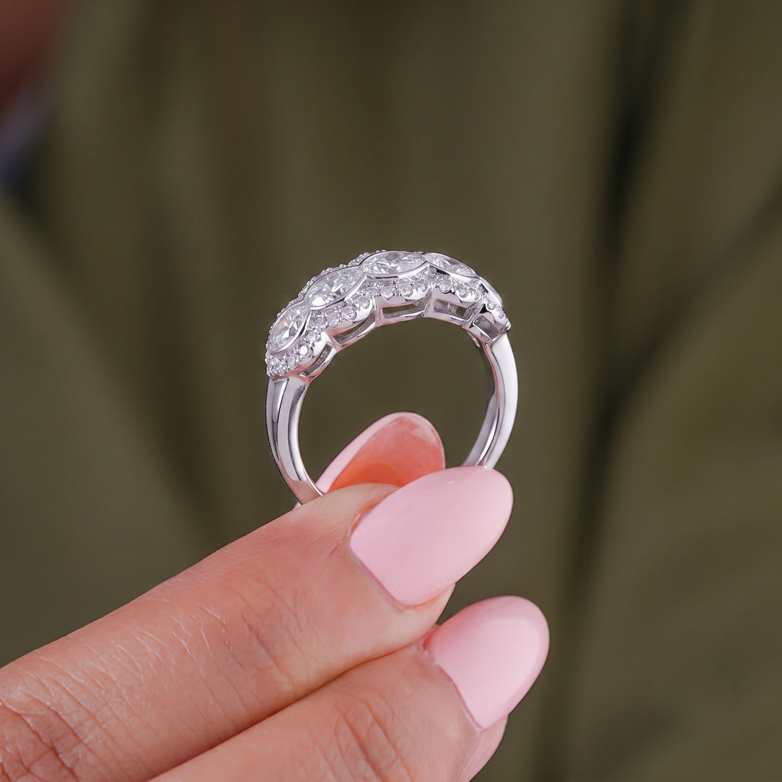 Halo wedding band with pear bezel set band.
