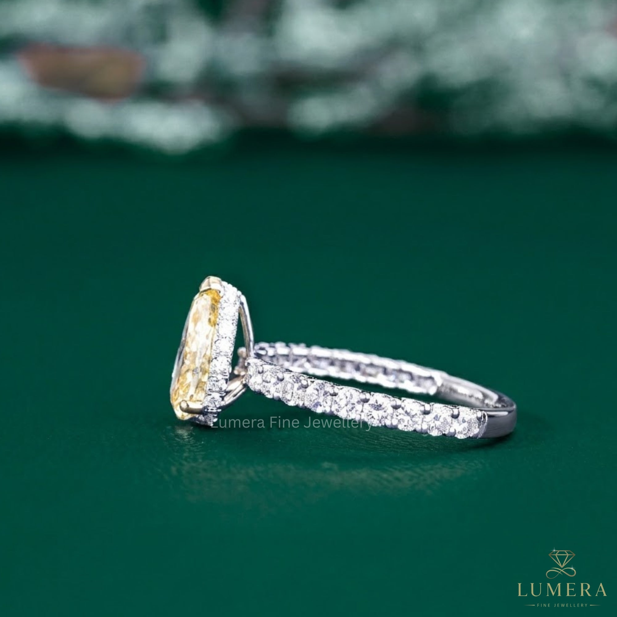 pear shaped diamond ring with cathedral setting ring.
