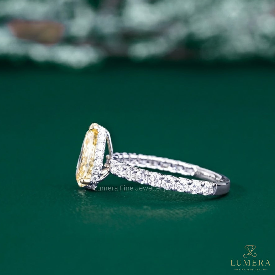 pear shaped diamond ring with cathedral setting ring.