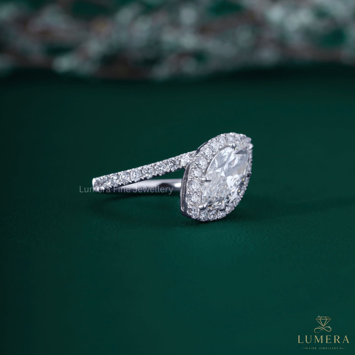 Marquise diamond engagement ring with bypass setting ring.