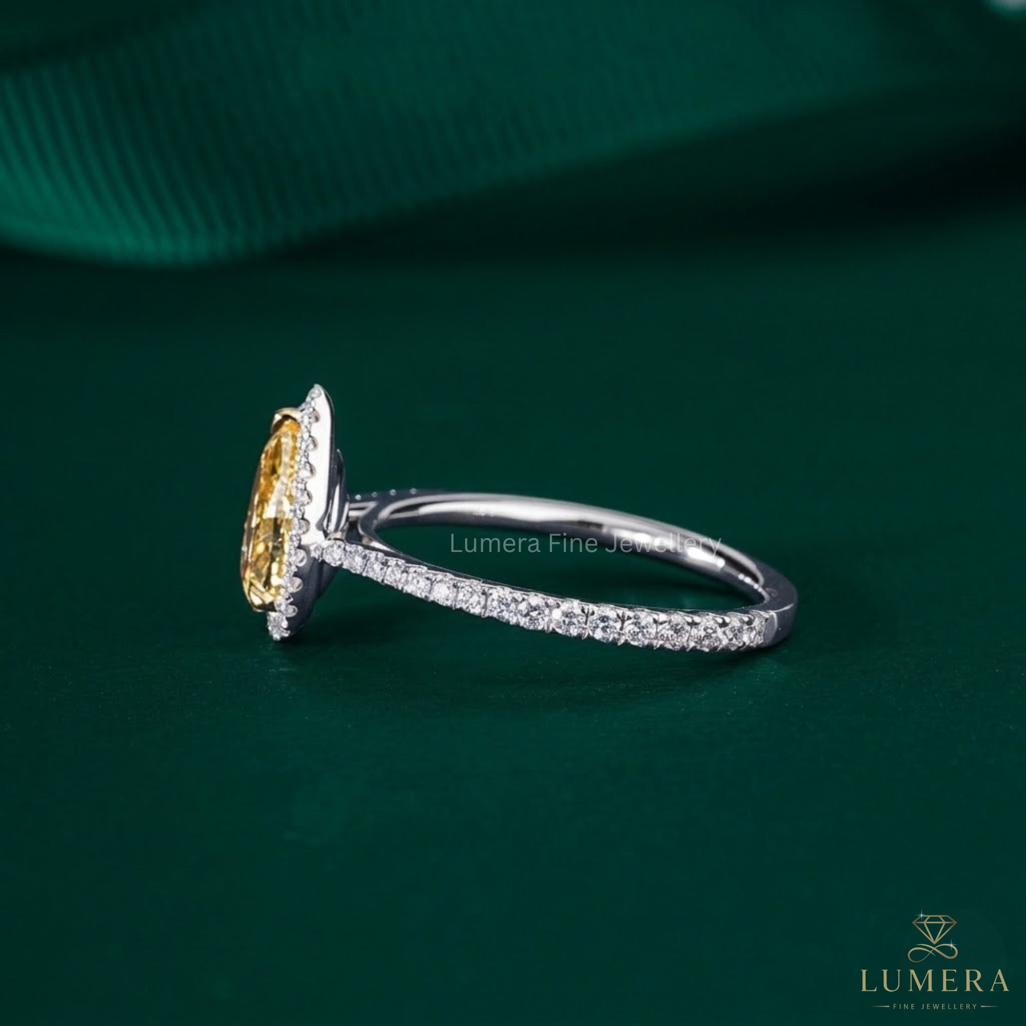pear shape yellow diamond ring with claw prong setting.