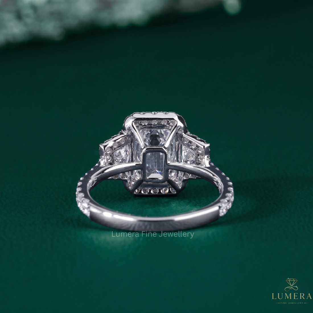 emerald engagement ring with trapezoid side stones.