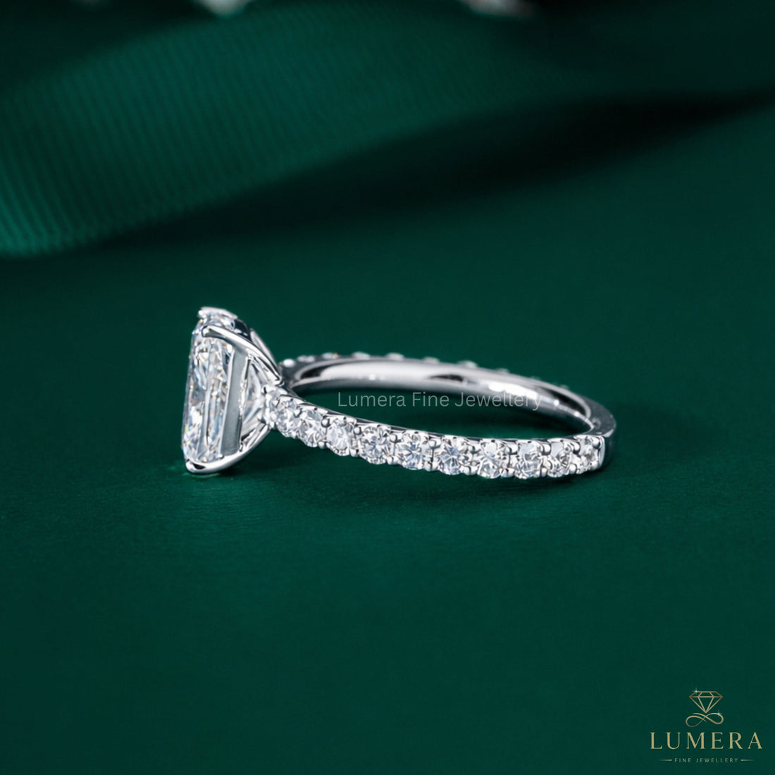 elongated cushion cut ring with round cut pave band.