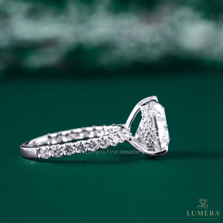 Heart cut diamond ring with pave ring setting.