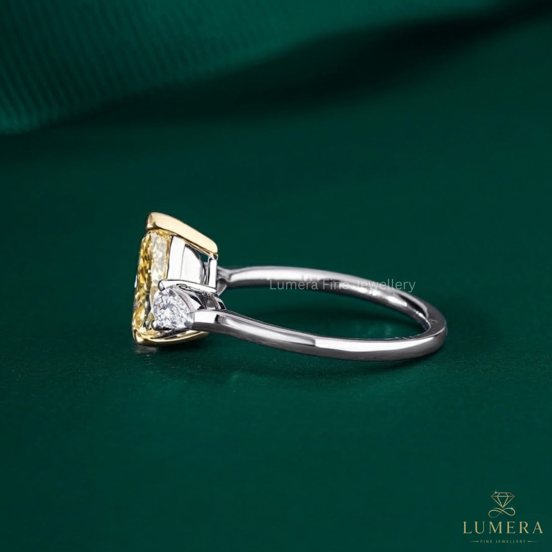 three stone ring with pear side stone.
