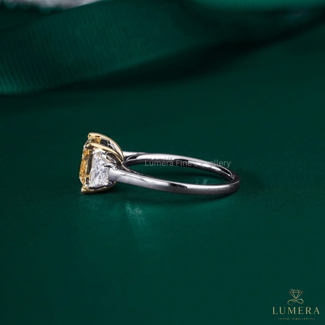 cushion diamond engagement ring with trapezoid side stones.