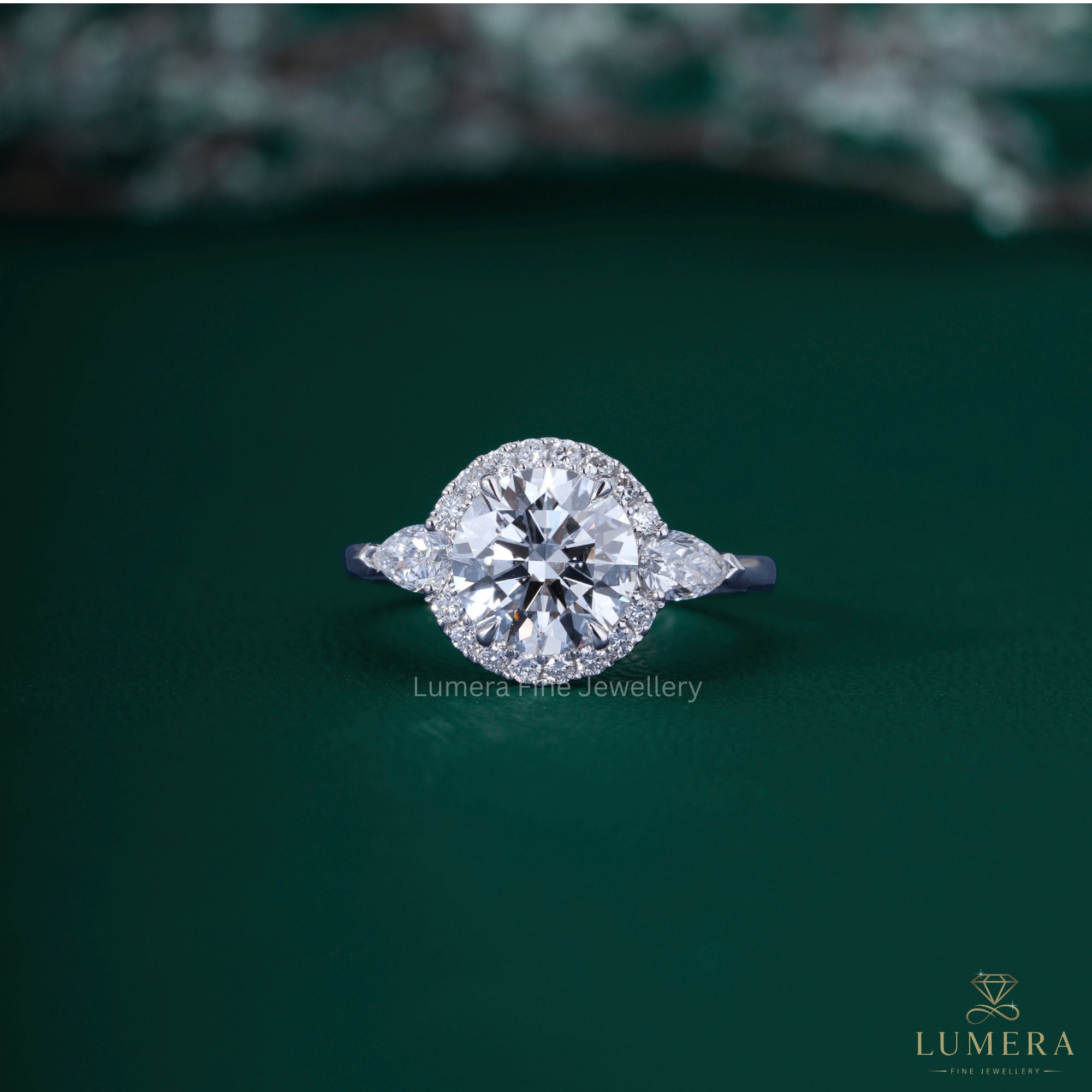 3 stone ring with pear side stone.