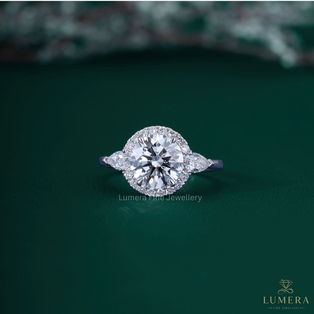 3 stone ring with pear side stone.