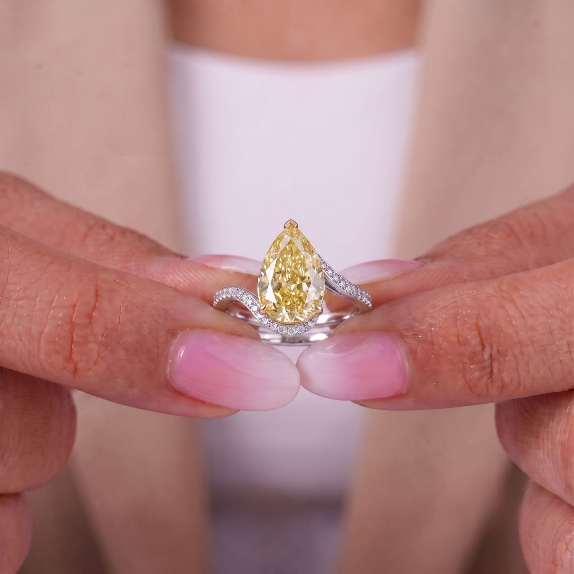 pear engagement ring with cathedral setting ring.
