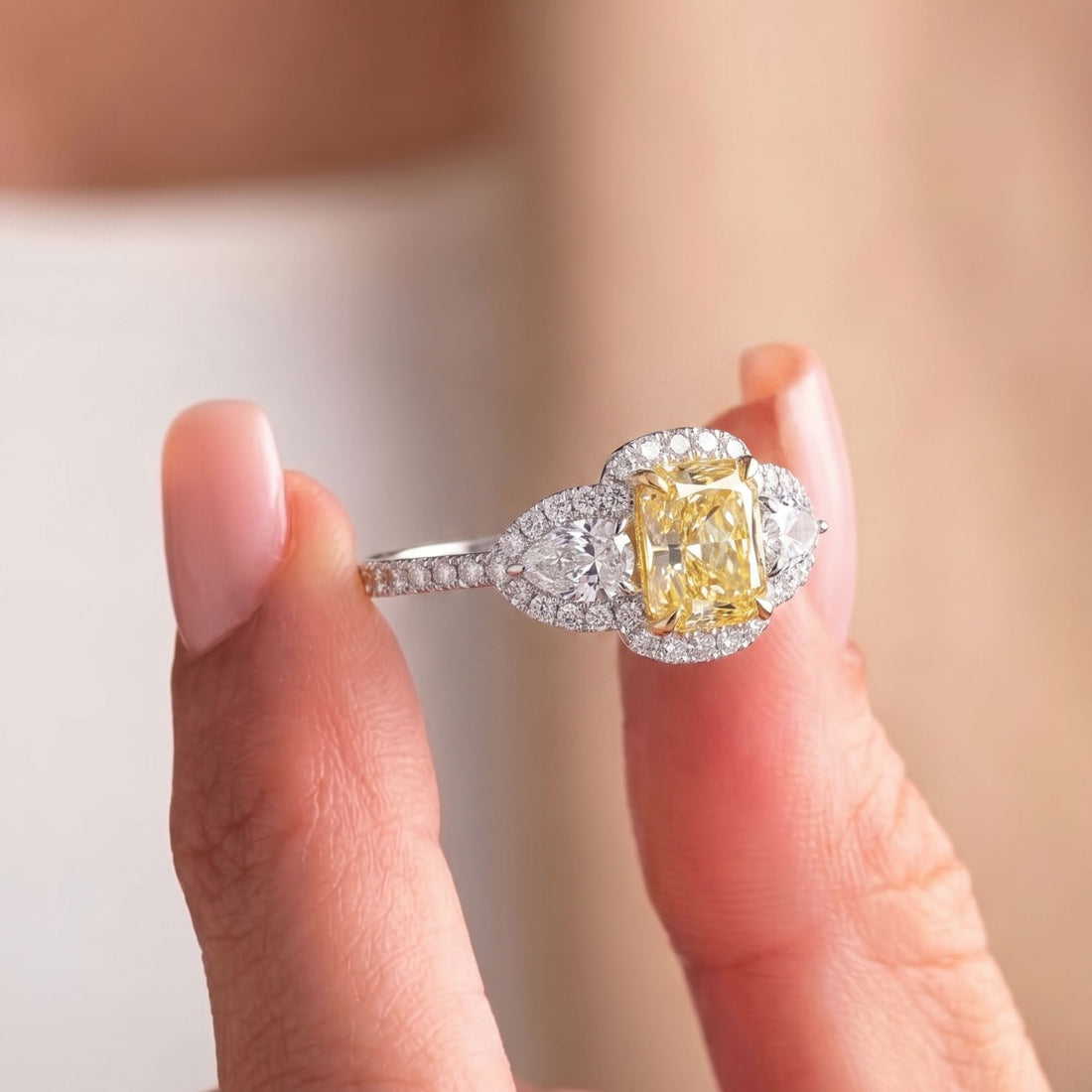 pear side stones with three stone engagement ring.
