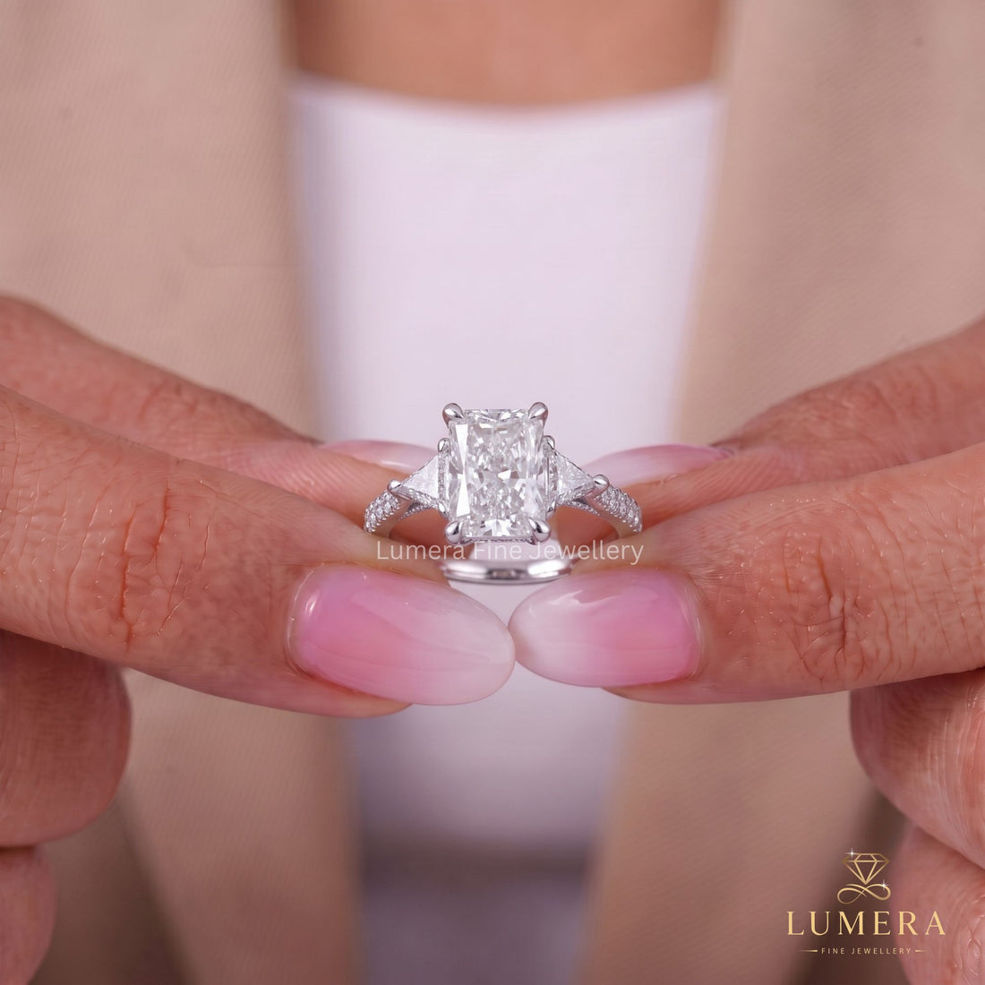 Three stone diamond ring with tapered shank setting.
