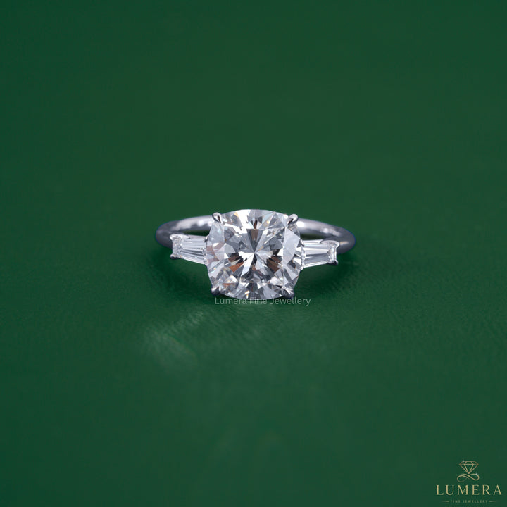 Square cushion engagement ring featuring a tapered baguette side stone.
