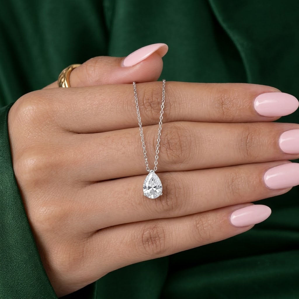 solitaire pear diamond with pear shaped pendant.
