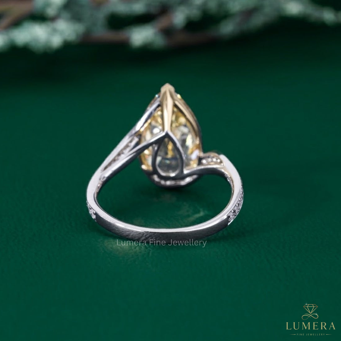 pear engagement ring with cathedral setting ring.
