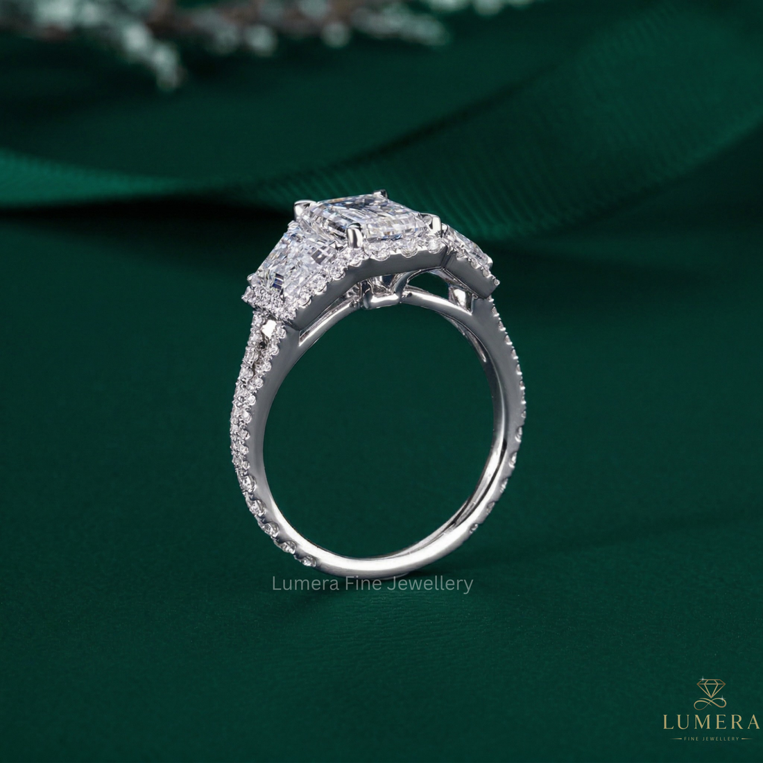 Emerald cut engagement ring on halo setting ring.
