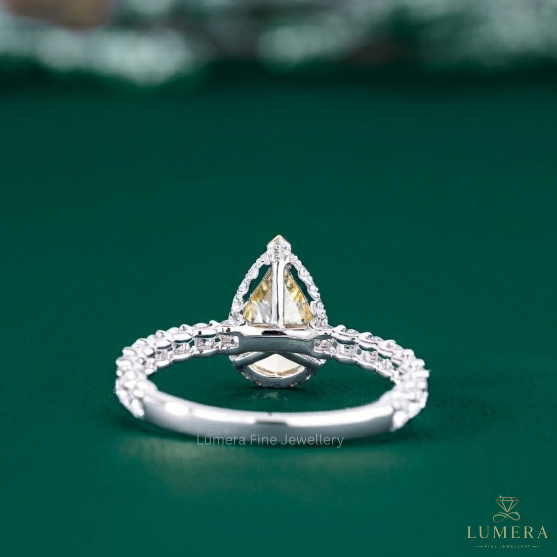 yellow pear diamond ring with two tone ring.
