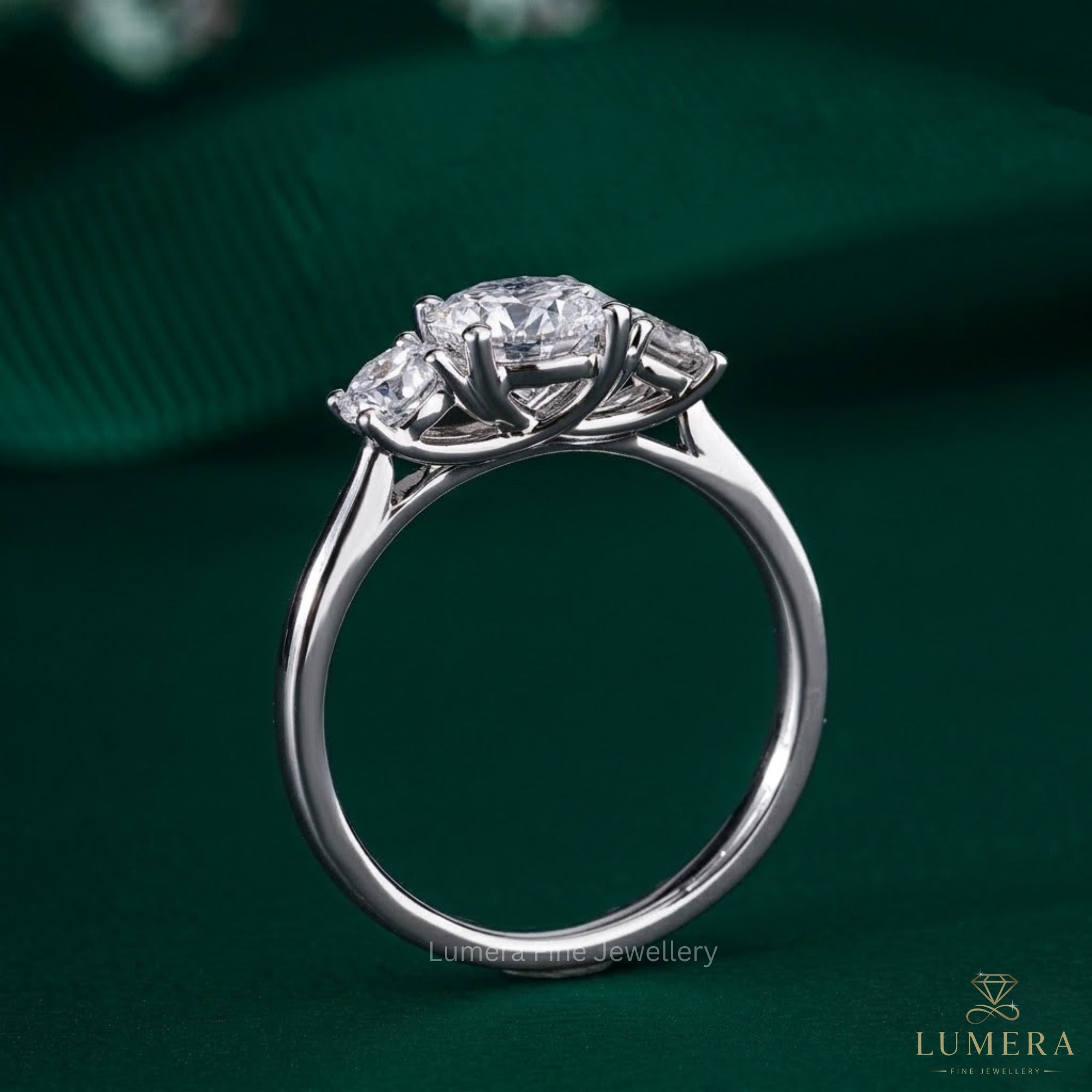 three stone engagement ring with 4 prong setting.
