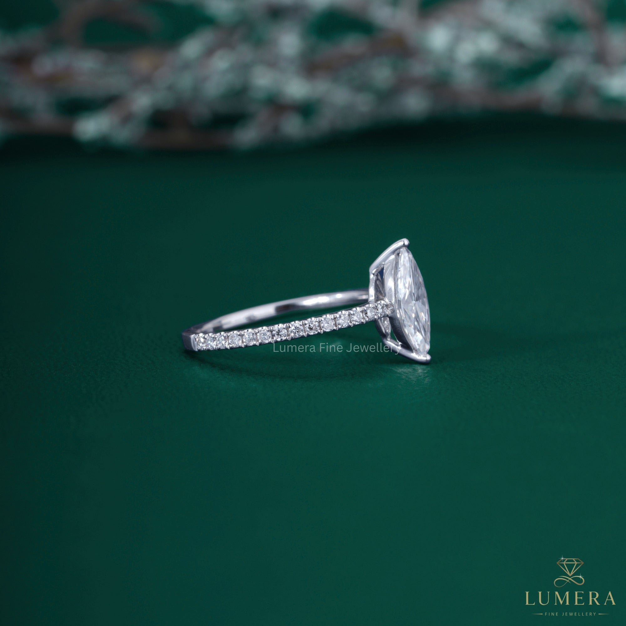 Marquise diamond ring with round prong setting.