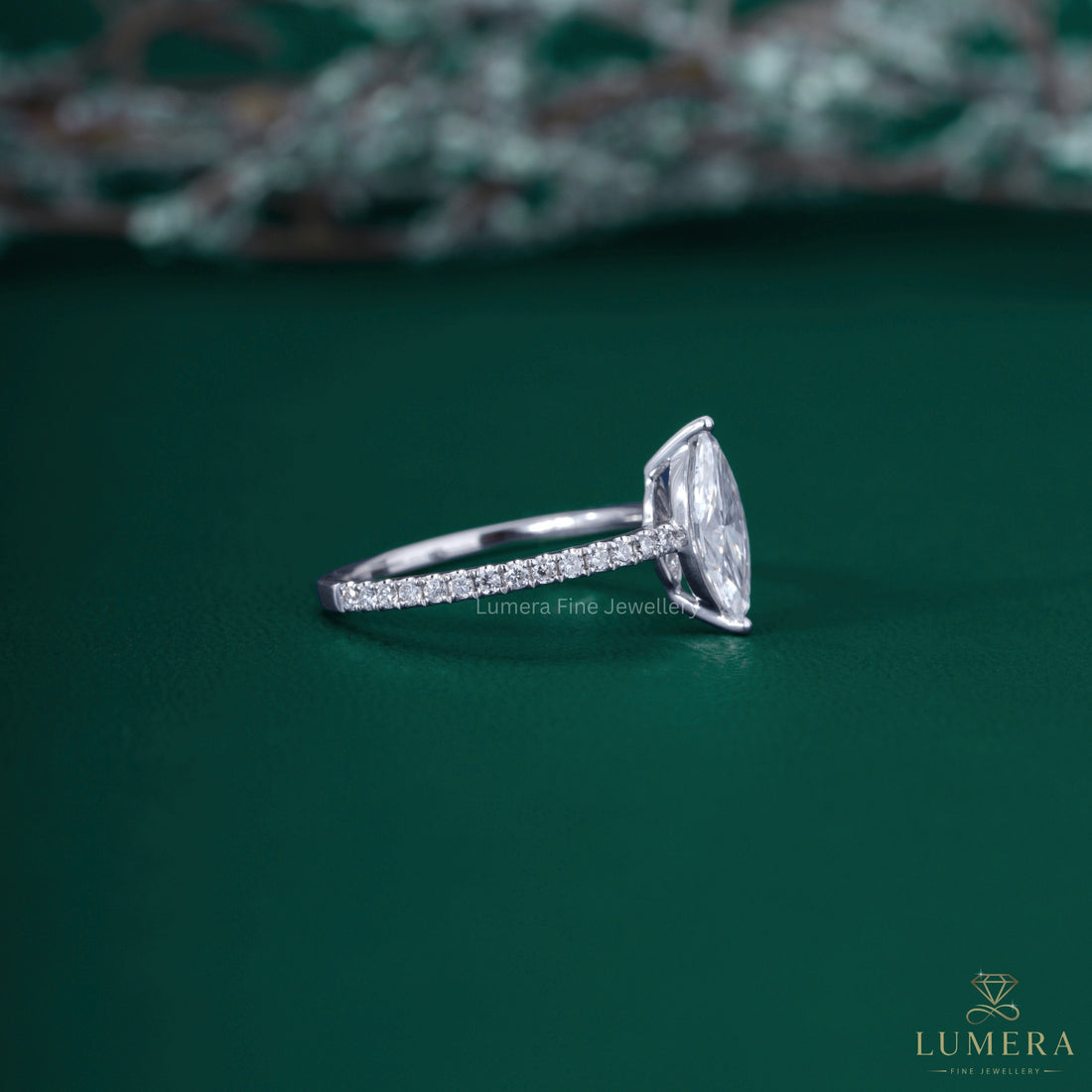 Marquise diamond ring with round prong setting.